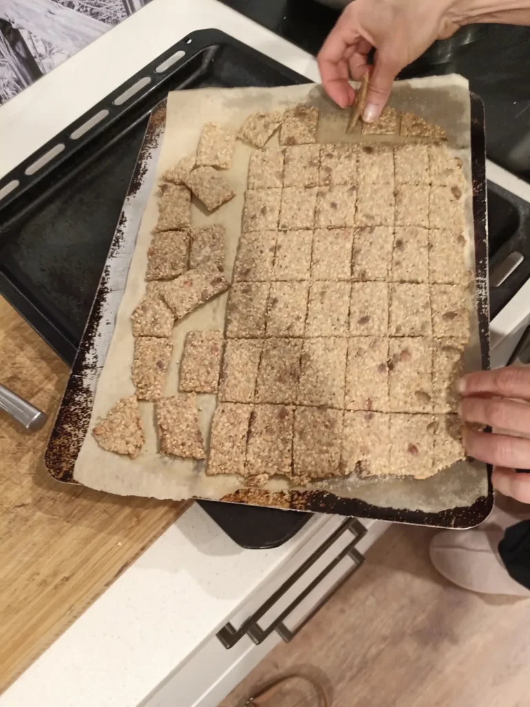 What to do with sourdough discard: a full tray of cracker dough scored into squares and ready for the oven