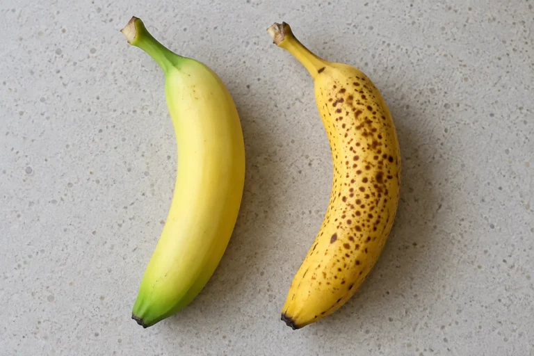How to make banana baby food: an unripe green-tipped banana beside a ripe spotted banana
